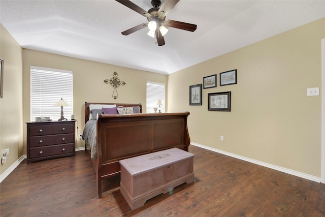 bedroom featuring dark wood finished floors, a ceiling fan, and baseboards