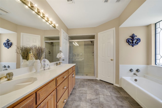 bathroom featuring double vanity, a stall shower, a bath, and a sink