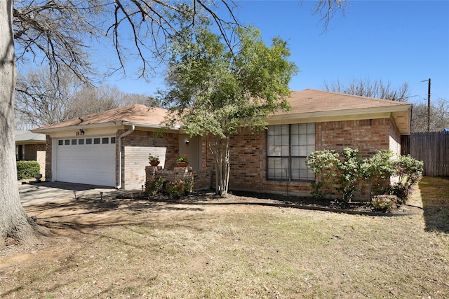 single story home featuring brick siding, an attached garage, a front lawn, fence, and driveway