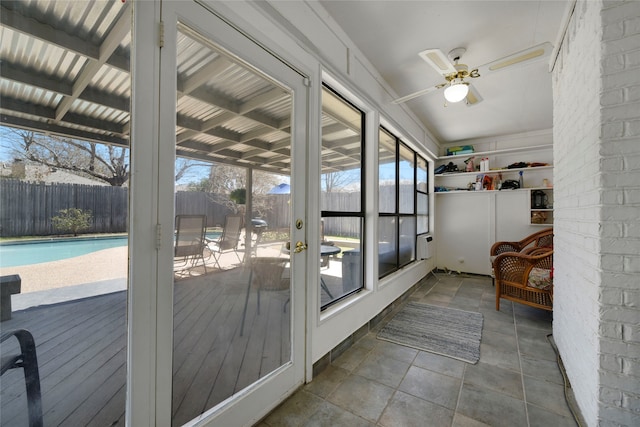 sunroom featuring a healthy amount of sunlight and ceiling fan