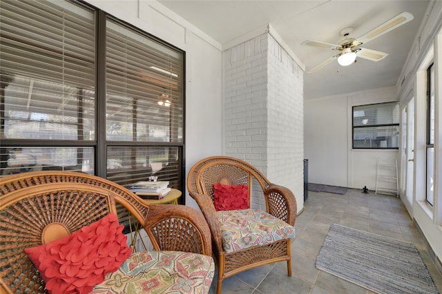 sunroom / solarium with a ceiling fan