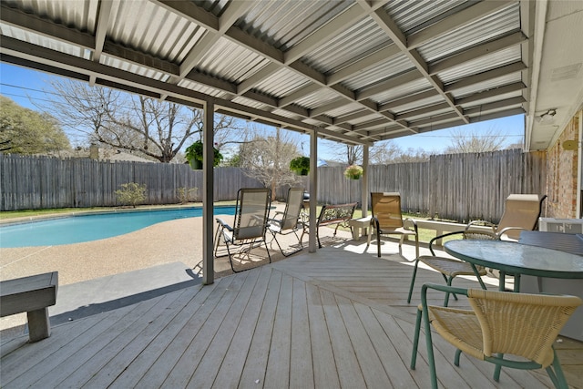 wooden deck featuring a fenced backyard and a fenced in pool