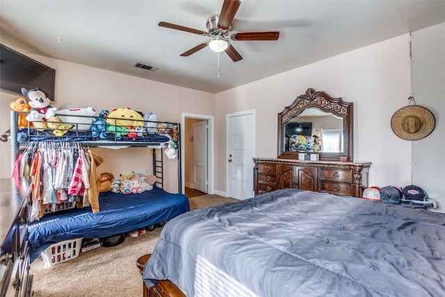 carpeted bedroom with visible vents and ceiling fan