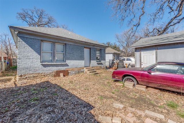 exterior space with entry steps and brick siding