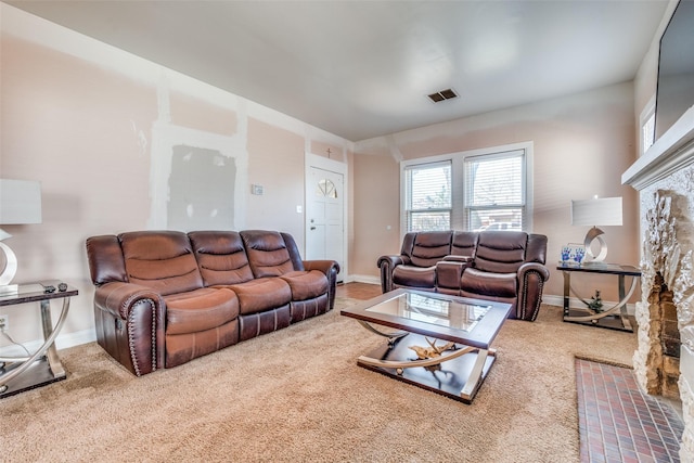 living room featuring carpet, visible vents, and baseboards