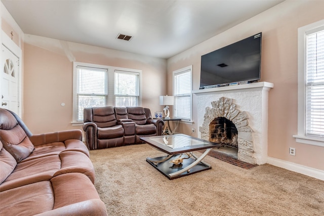 living area featuring carpet, a fireplace, visible vents, and baseboards