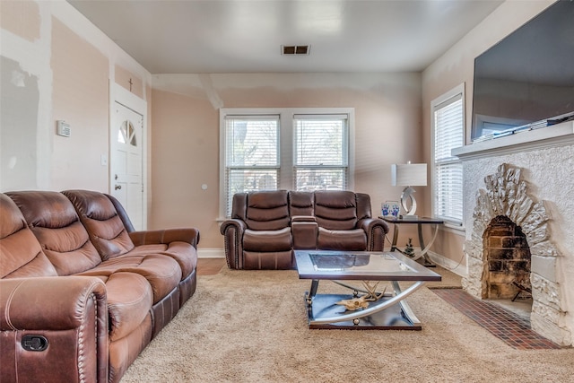 living area featuring visible vents, a fireplace, and baseboards