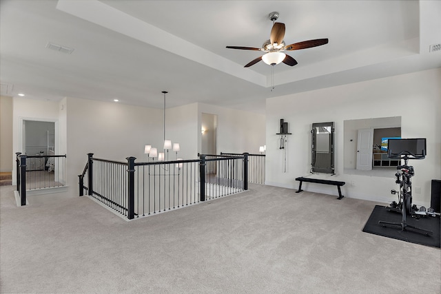 exercise area with carpet floors, recessed lighting, a raised ceiling, and visible vents