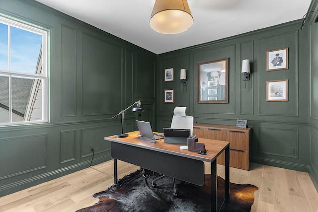 home office featuring a decorative wall and light wood finished floors