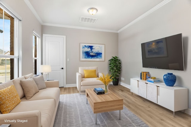 living area featuring light wood-style floors, visible vents, and crown molding