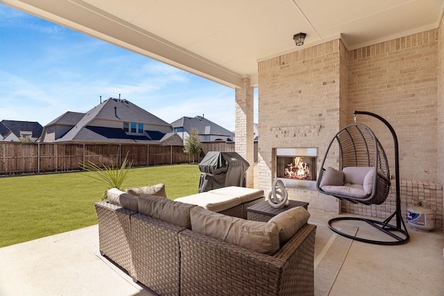 view of patio featuring an outdoor living space with a fireplace, a fenced backyard, and a grill