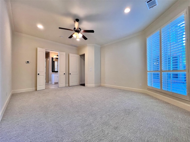 unfurnished bedroom featuring light carpet, ornamental molding, visible vents, and baseboards