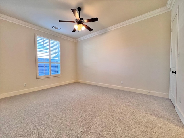 spare room with light carpet, ornamental molding, visible vents, and baseboards