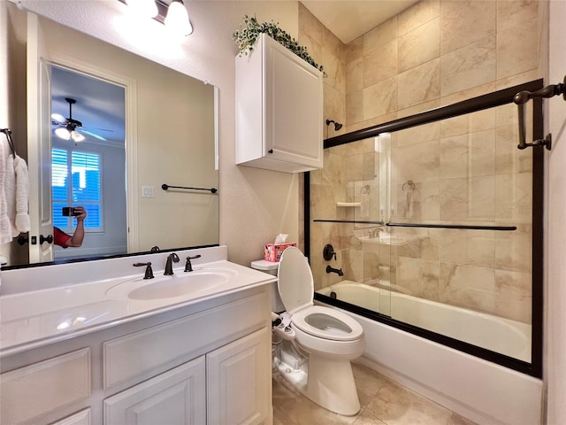 full bathroom with combined bath / shower with glass door, vanity, toilet, and tile patterned floors