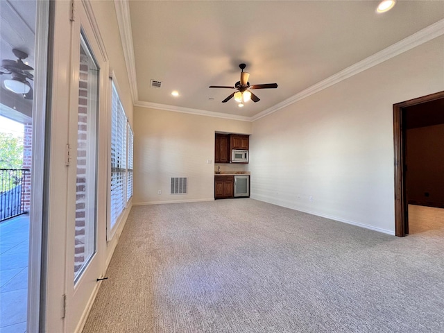 unfurnished living room with ceiling fan, visible vents, and light colored carpet