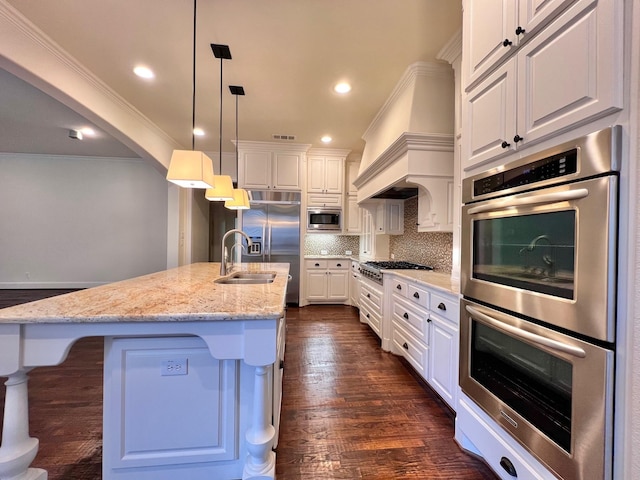 kitchen featuring tasteful backsplash, appliances with stainless steel finishes, white cabinets, and a sink