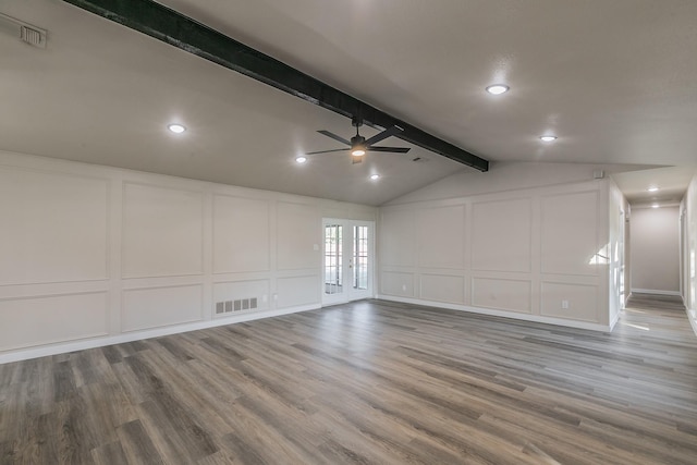 interior space with visible vents, a decorative wall, and wood finished floors