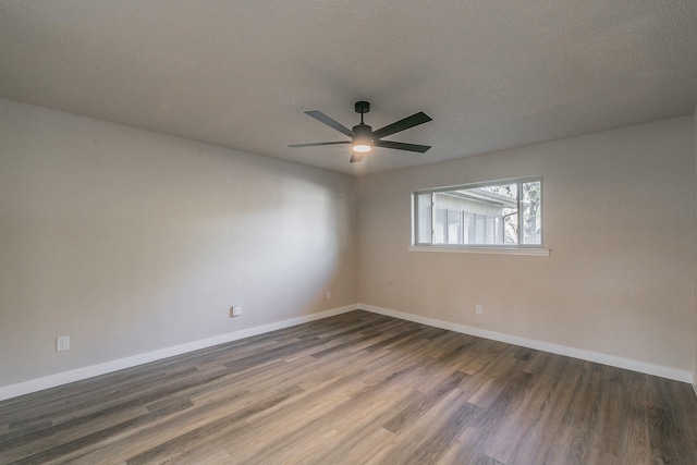 spare room featuring a ceiling fan, a textured ceiling, baseboards, and wood finished floors