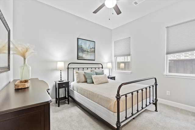 bedroom with light carpet, baseboards, and a ceiling fan