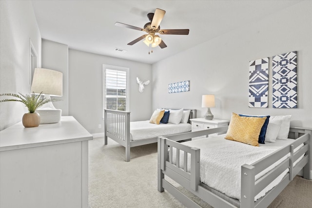 bedroom featuring light carpet, baseboards, visible vents, and a ceiling fan