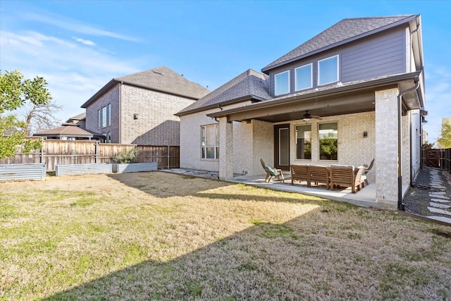 rear view of house featuring a lawn, fence, a ceiling fan, and a patio