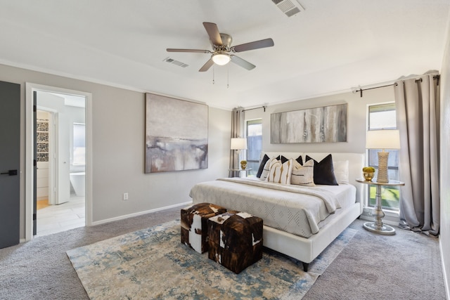 bedroom with baseboards, visible vents, carpet flooring, and ensuite bathroom