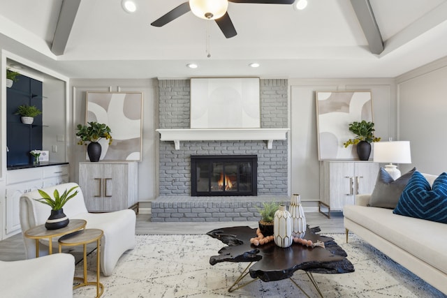 living room featuring beam ceiling, recessed lighting, a brick fireplace, ceiling fan, and wood finished floors