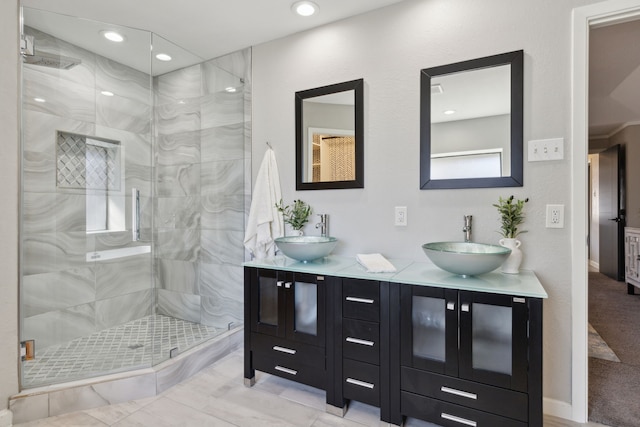 bathroom with double vanity, a stall shower, a sink, and recessed lighting