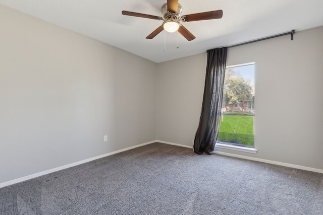 spare room with carpet floors, baseboards, and a ceiling fan