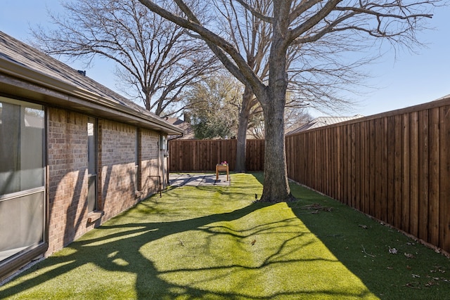 view of yard with a fenced backyard