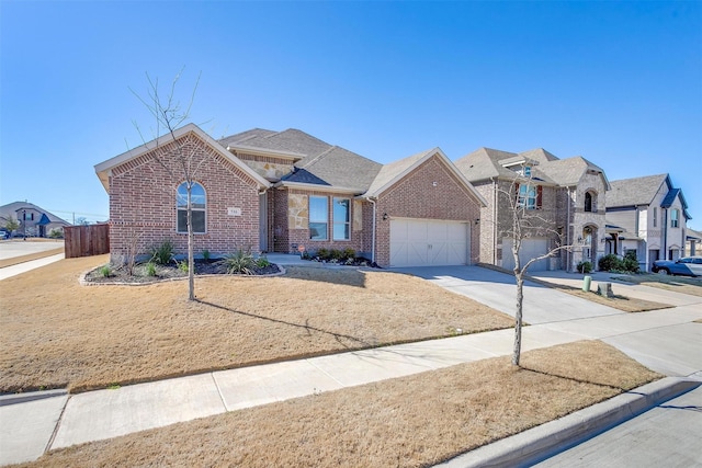 view of front of property with driveway, a garage, fence, and brick siding