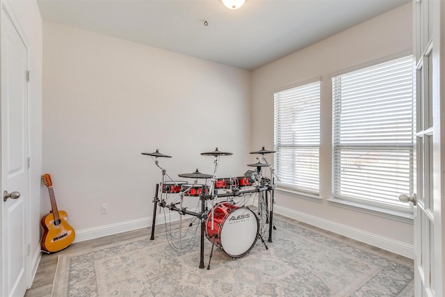 rec room featuring baseboards and wood finished floors