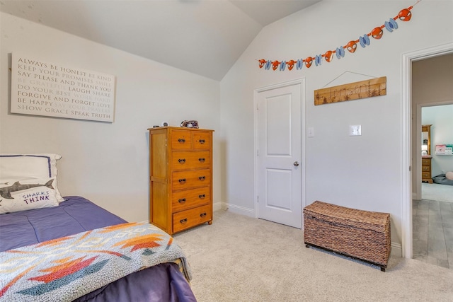 bedroom featuring lofted ceiling and carpet flooring