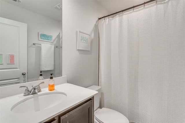 bathroom featuring toilet and vanity