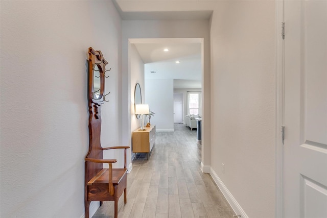 hallway with light wood finished floors, recessed lighting, and baseboards