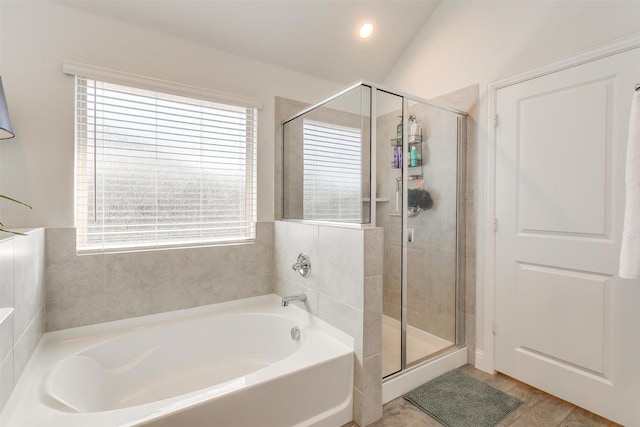 full bathroom featuring vaulted ceiling, a stall shower, a garden tub, and recessed lighting