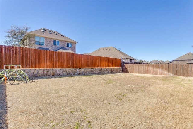 view of yard with a fenced backyard