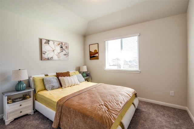 bedroom featuring dark colored carpet, vaulted ceiling, and baseboards