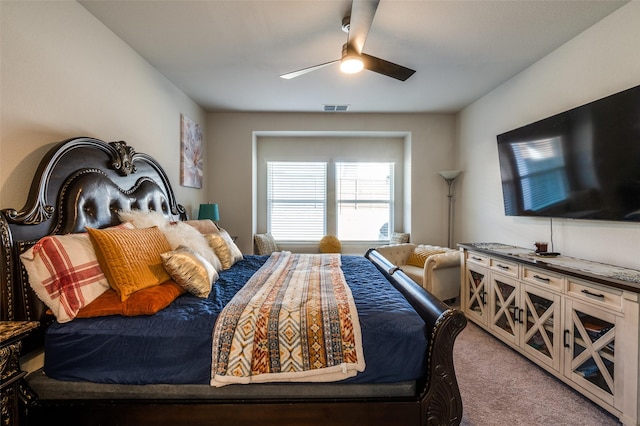 carpeted bedroom with visible vents and a ceiling fan