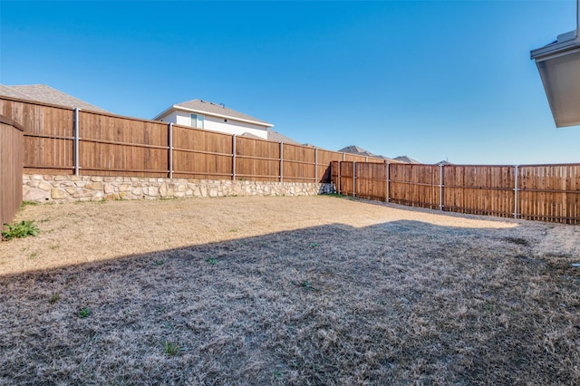 view of yard with a fenced backyard