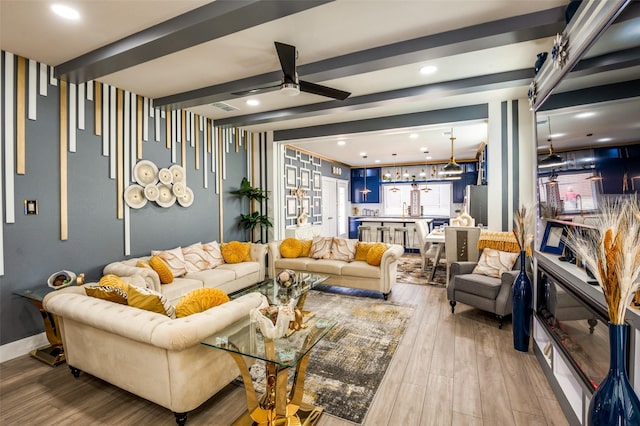 living room featuring baseboards, a ceiling fan, wood finished floors, beamed ceiling, and recessed lighting