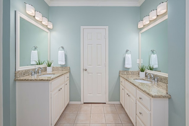 bathroom featuring crown molding, two vanities, a sink, and tile patterned floors