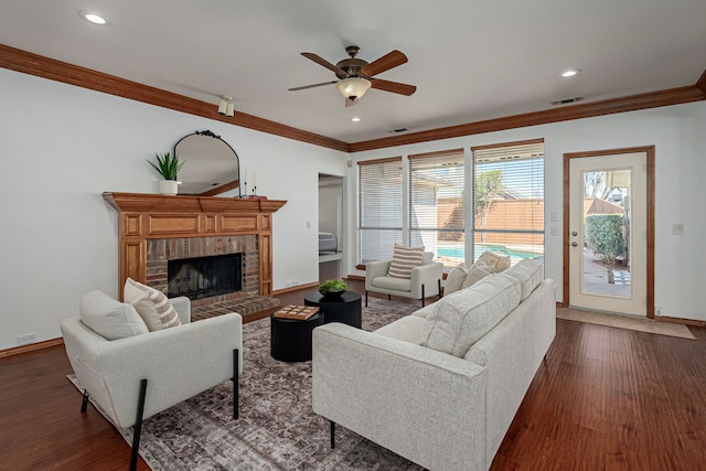 living area with ornamental molding, dark wood-style flooring, and visible vents