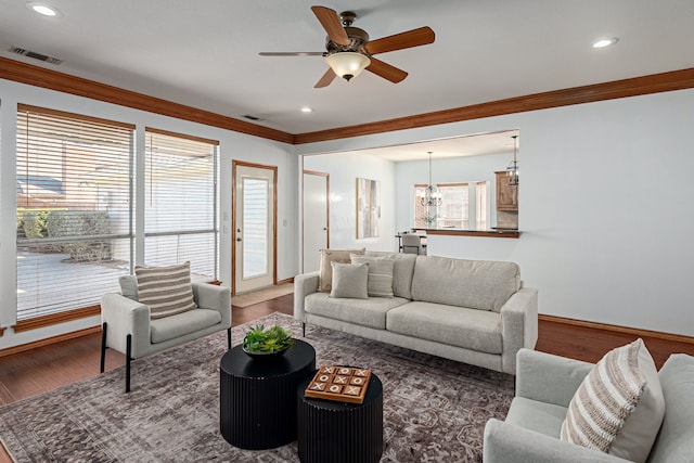 living room featuring crown molding, visible vents, wood finished floors, and recessed lighting