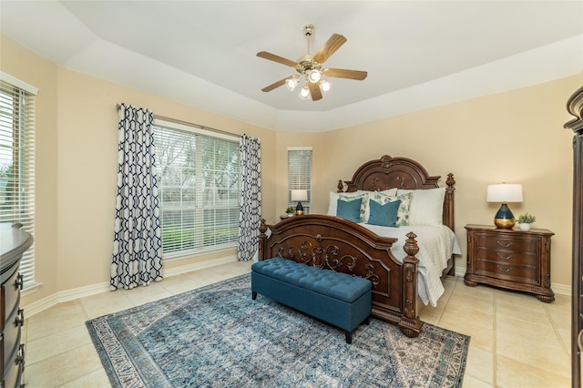 bedroom with ceiling fan, light tile patterned flooring, and baseboards