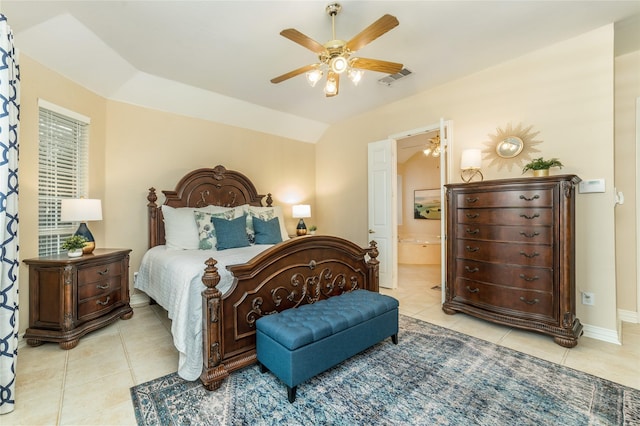 bedroom with light tile patterned floors, connected bathroom, visible vents, and baseboards