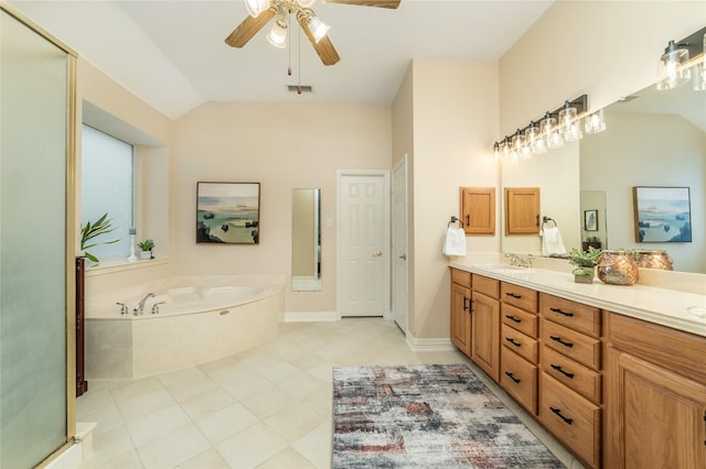 bathroom with a sink, visible vents, vaulted ceiling, a bath, and double vanity