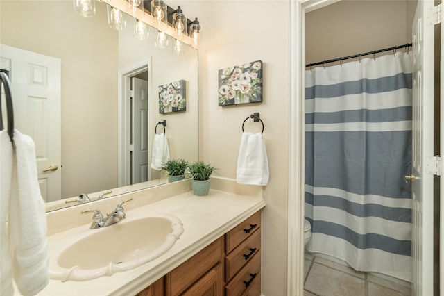 bathroom featuring curtained shower, vanity, toilet, and tile patterned floors