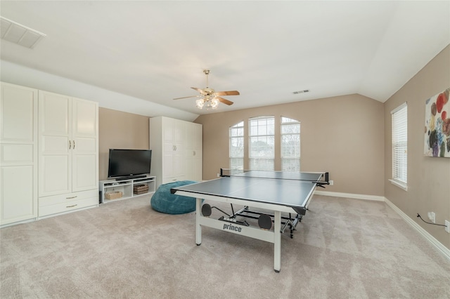 recreation room featuring light carpet, baseboards, visible vents, and vaulted ceiling