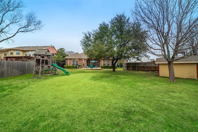 view of yard featuring fence and a playground